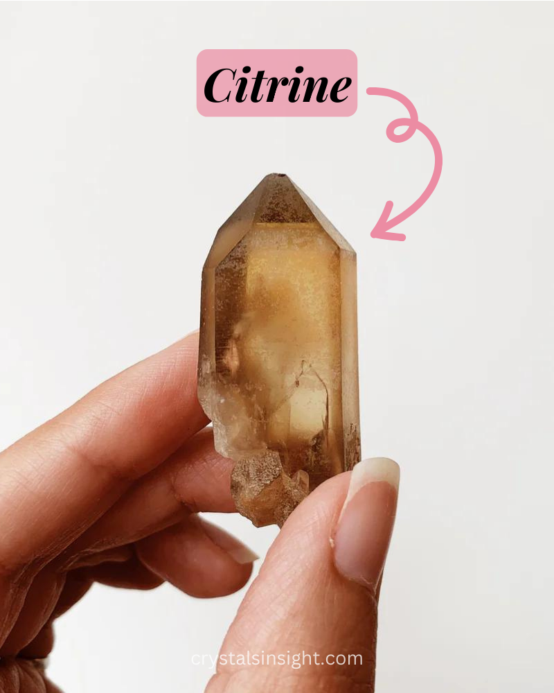 A girl holding a Citrine stone in her hand. 